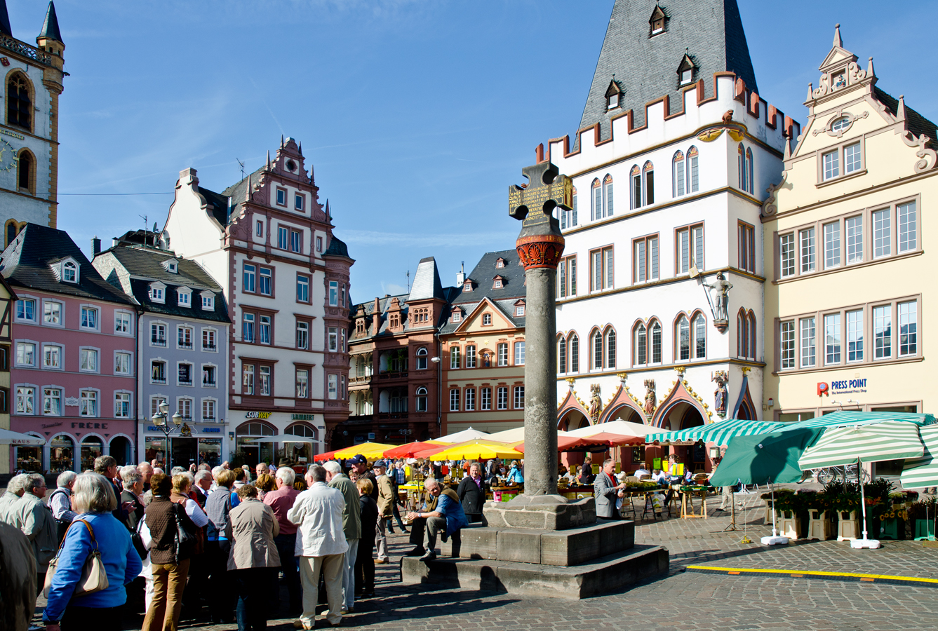 Trevír - Náměstí Hauptmarkt s tržním sloupem zakončeným křížem, nápadný bílý dům za ním je pozdně gotická Steipe